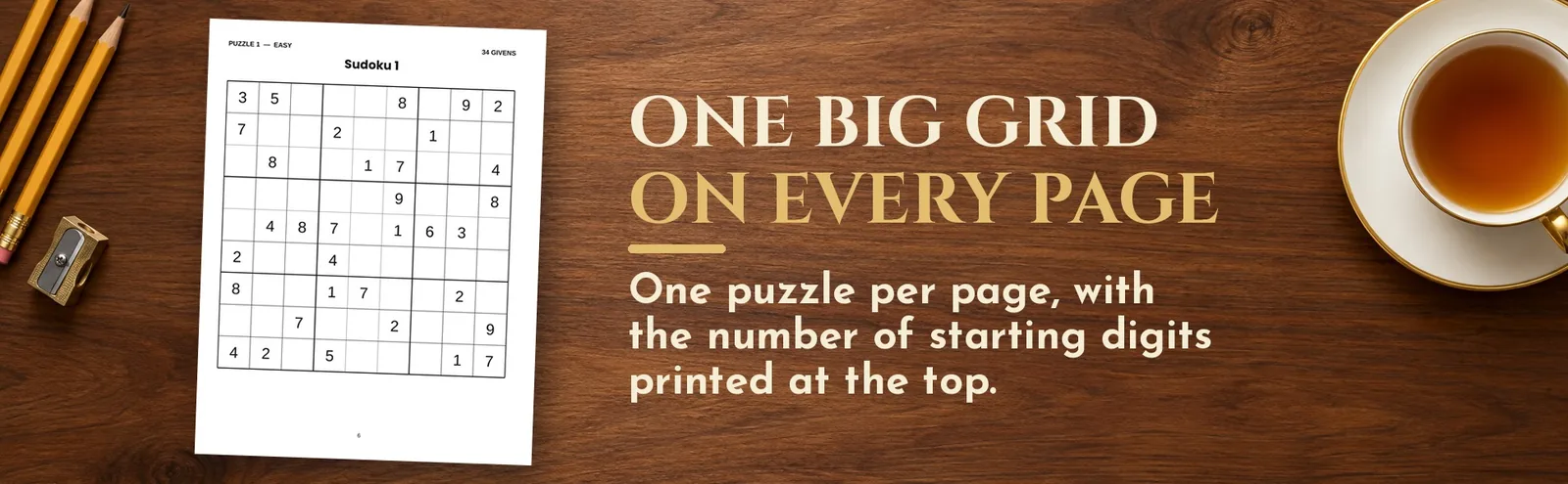 A full sudoku puzzle page lying on a wooden desk beside pencils and a cup of tea.